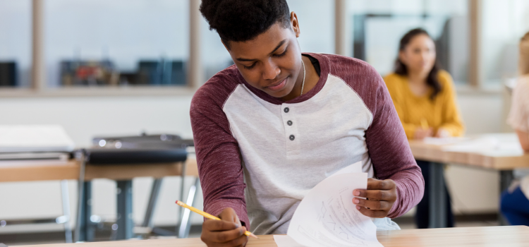 A student taking an exam in a classroom