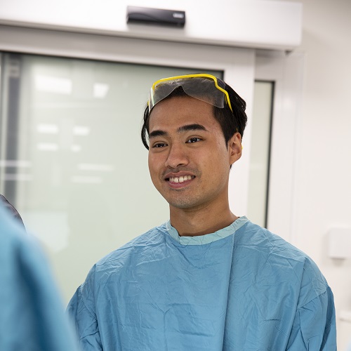 Medical student wearing hospital gowns and gloves