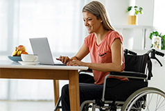 woman in wheelchair sitting at computer