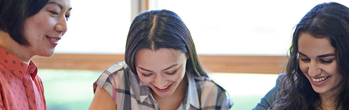 Female teacher working with two female students