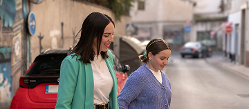 Cartoon child in a fantasy landscape with playful creatures.