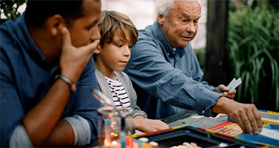 child playing game with family