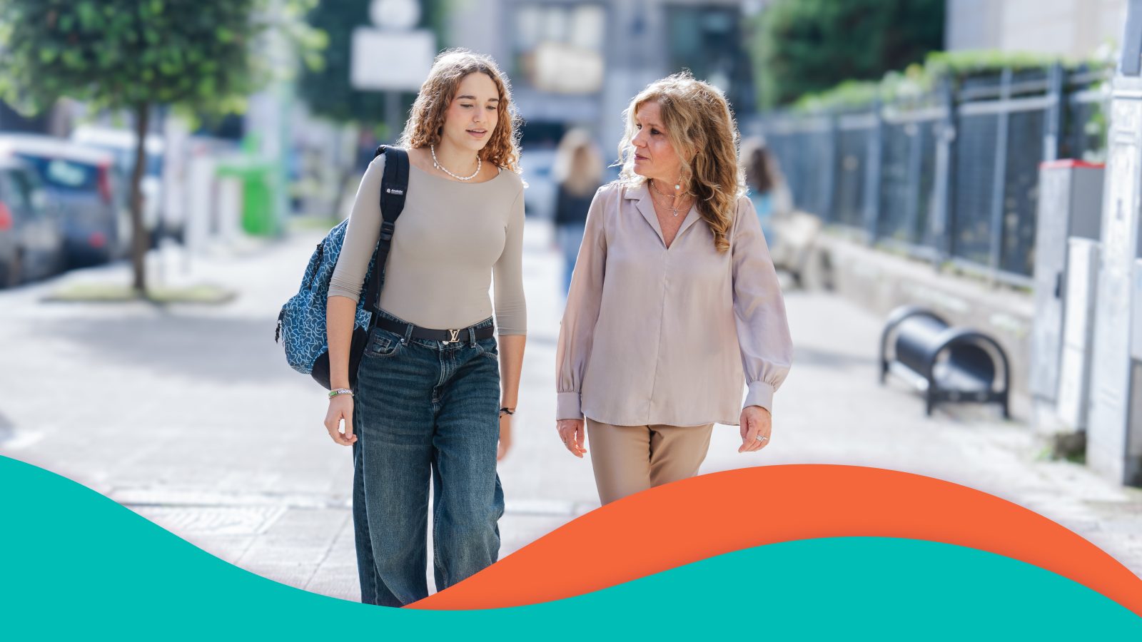 Student and teacher walking and talking.