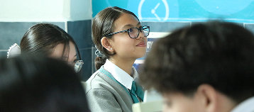 Student in classroom, reflecting A2 Key exam readiness.