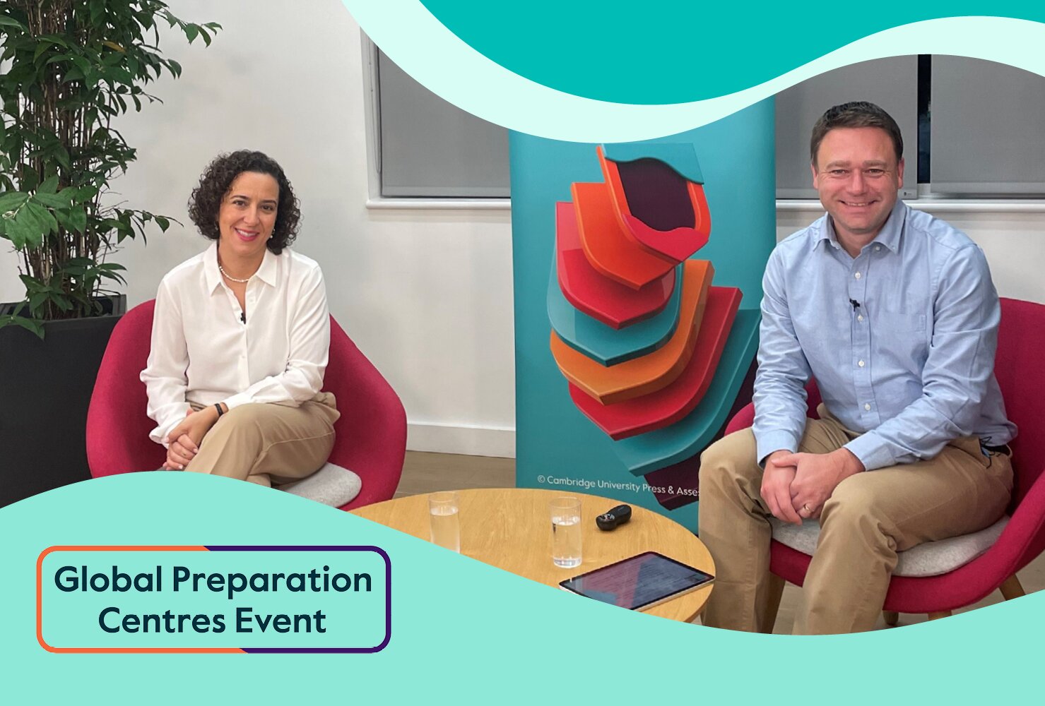 Two speakers seated in red chairs beside a table at a Global Preparation Centres event