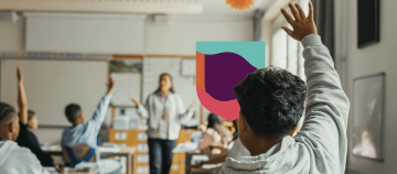 Students raising hands in a classroom.
