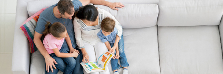 parents and child on sofa