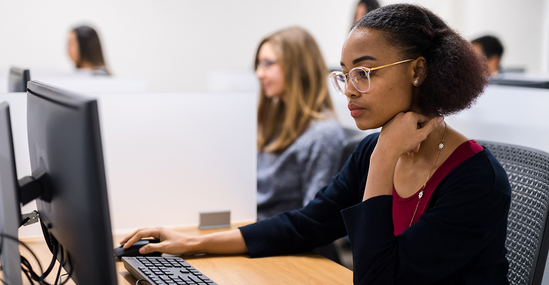 Student using a computer in a classroom.