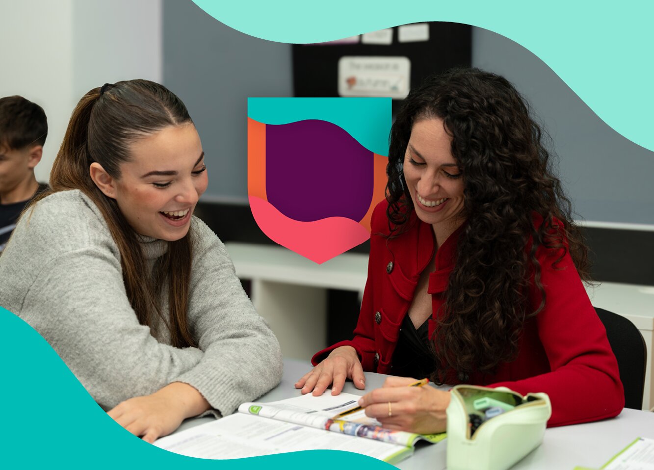 Teacher supporting a student during a classroom activity.