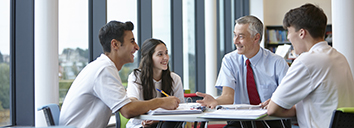 University lecturer speaking in English with three students