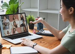 Person attending an online meeting on a laptop.