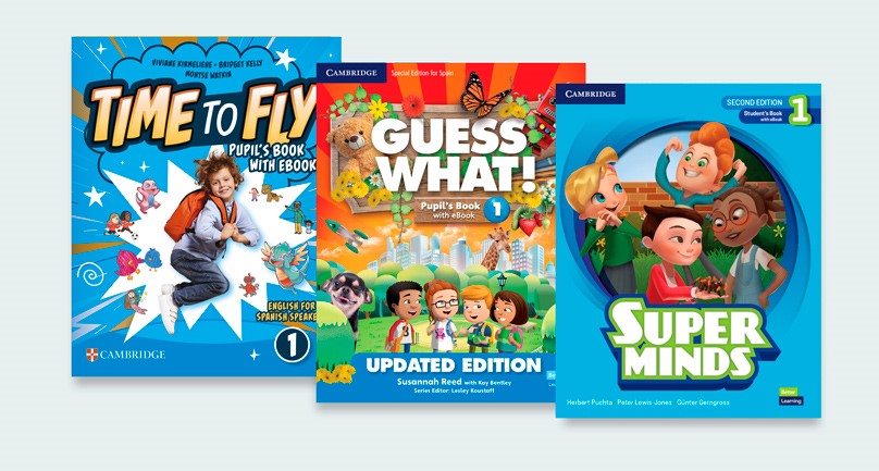 Tres libros Guess What apilados.