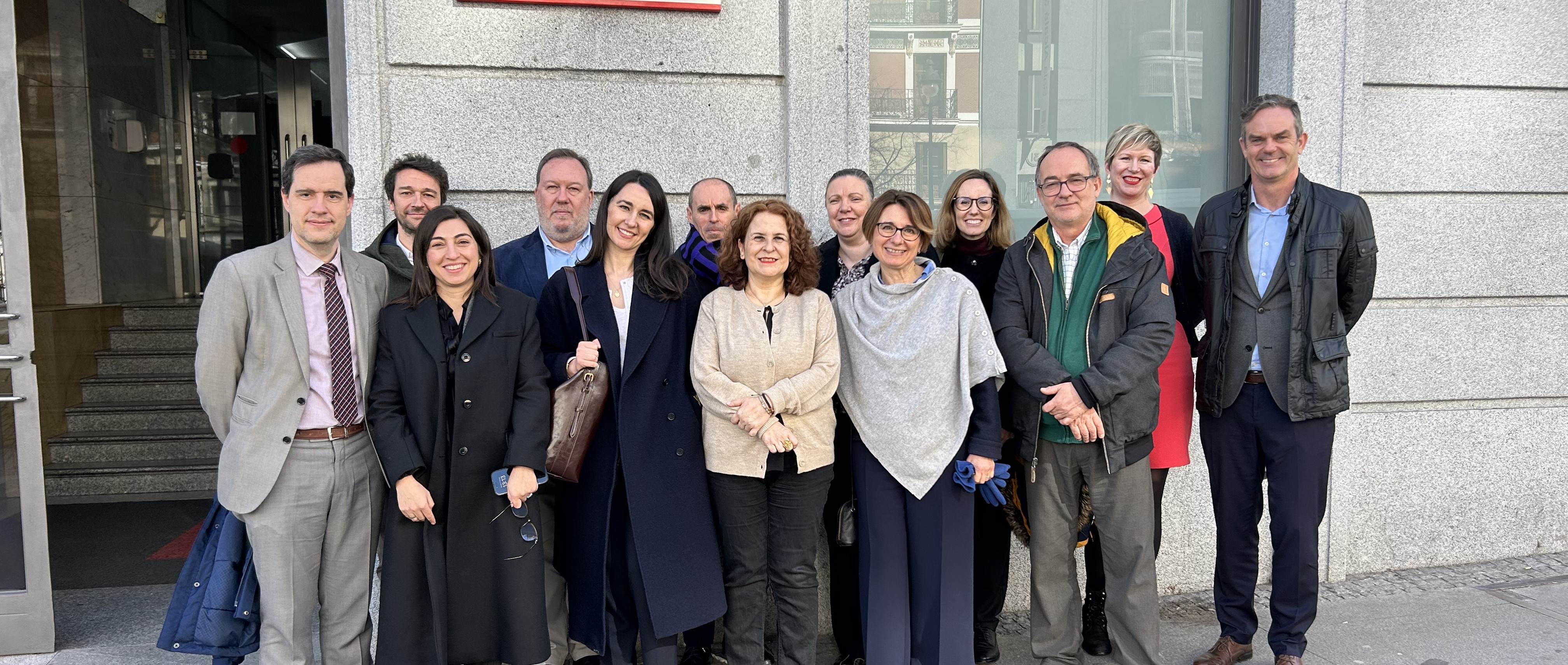 People gathered outside a building for a bilingual education meeting