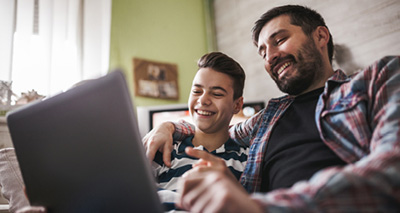 parent with child on laptop