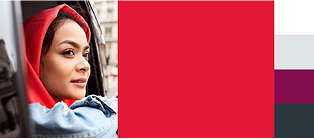 Woman in red headscarf looking out of car window.