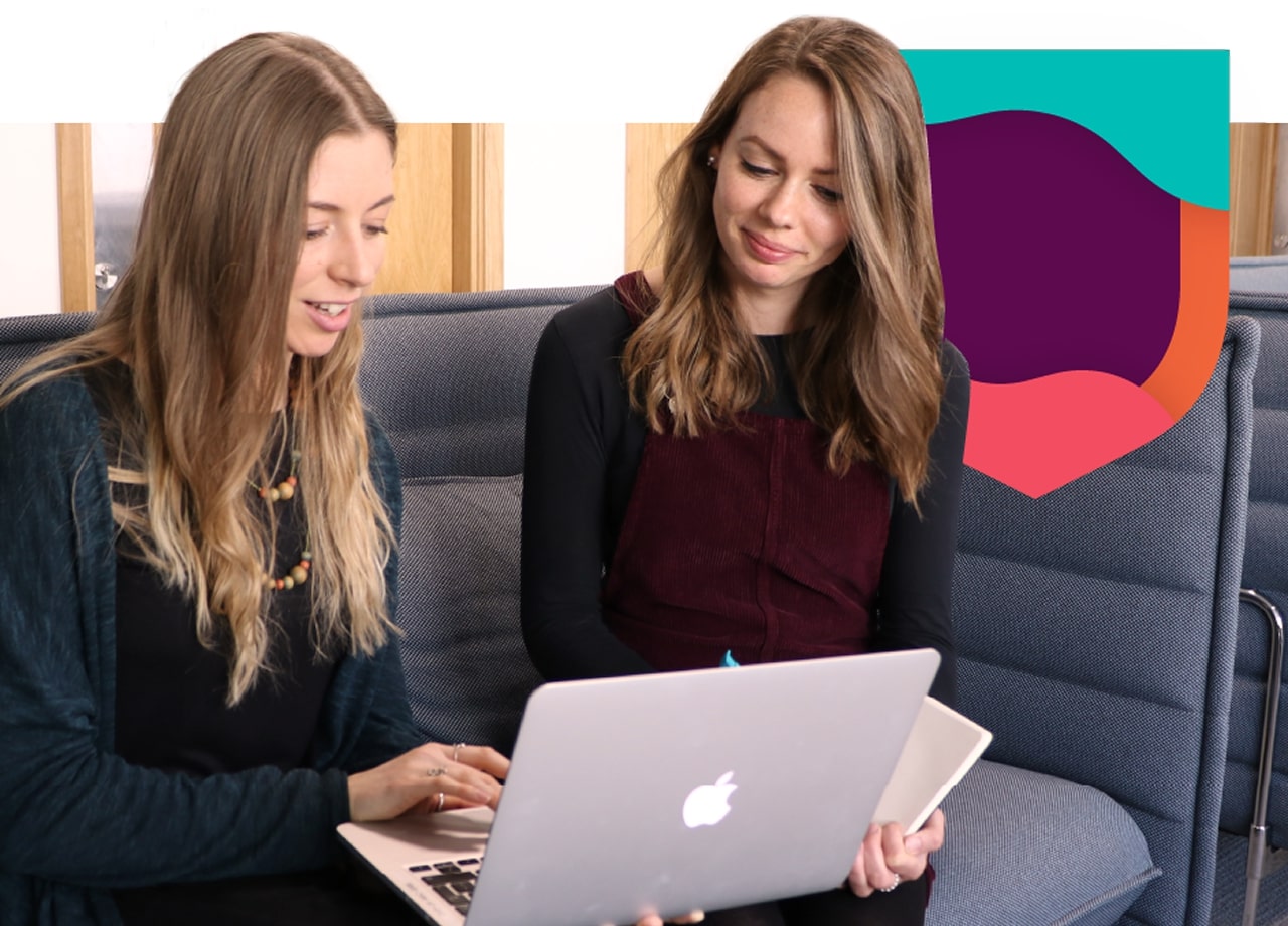Women discussing language learning on laptop