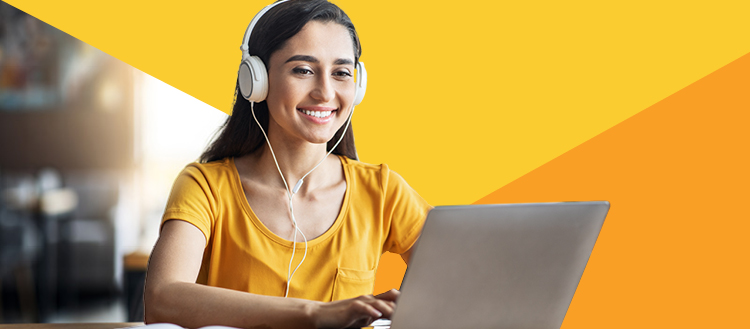 Woman with headphones at laptop.