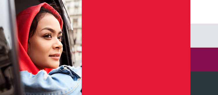 Woman in red hoodie looking out window, IELTS