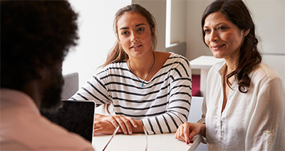 student and parent talking teacher