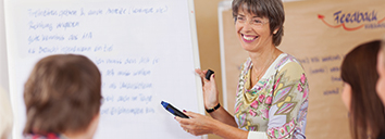 Teacher trainer speaking to their class in English