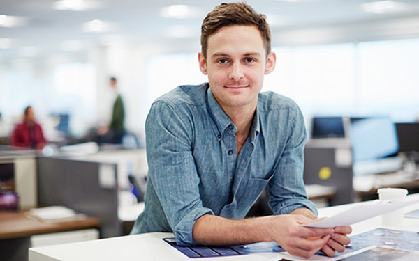 Man standing at desk in office