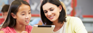 Teacher and student doing an English activity on a tablet